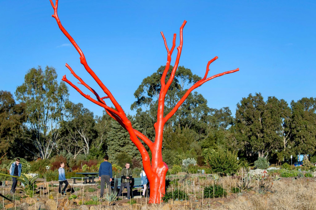 A red painted tree sculpture at The Botanic Gardens