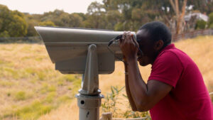 Person looking through binoculars at Werribee Park Tourism Precinct